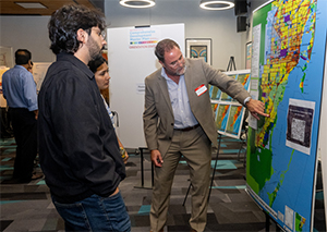 A person pointing at information on a map to others